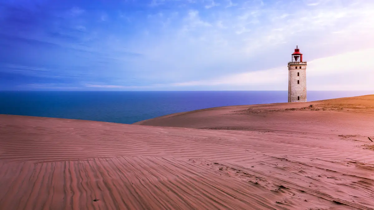 Standing beside the serene North Sea, Rubjerg Knude Lighthouse once guided shipping lanes from 1900 until 1968. Built upon…