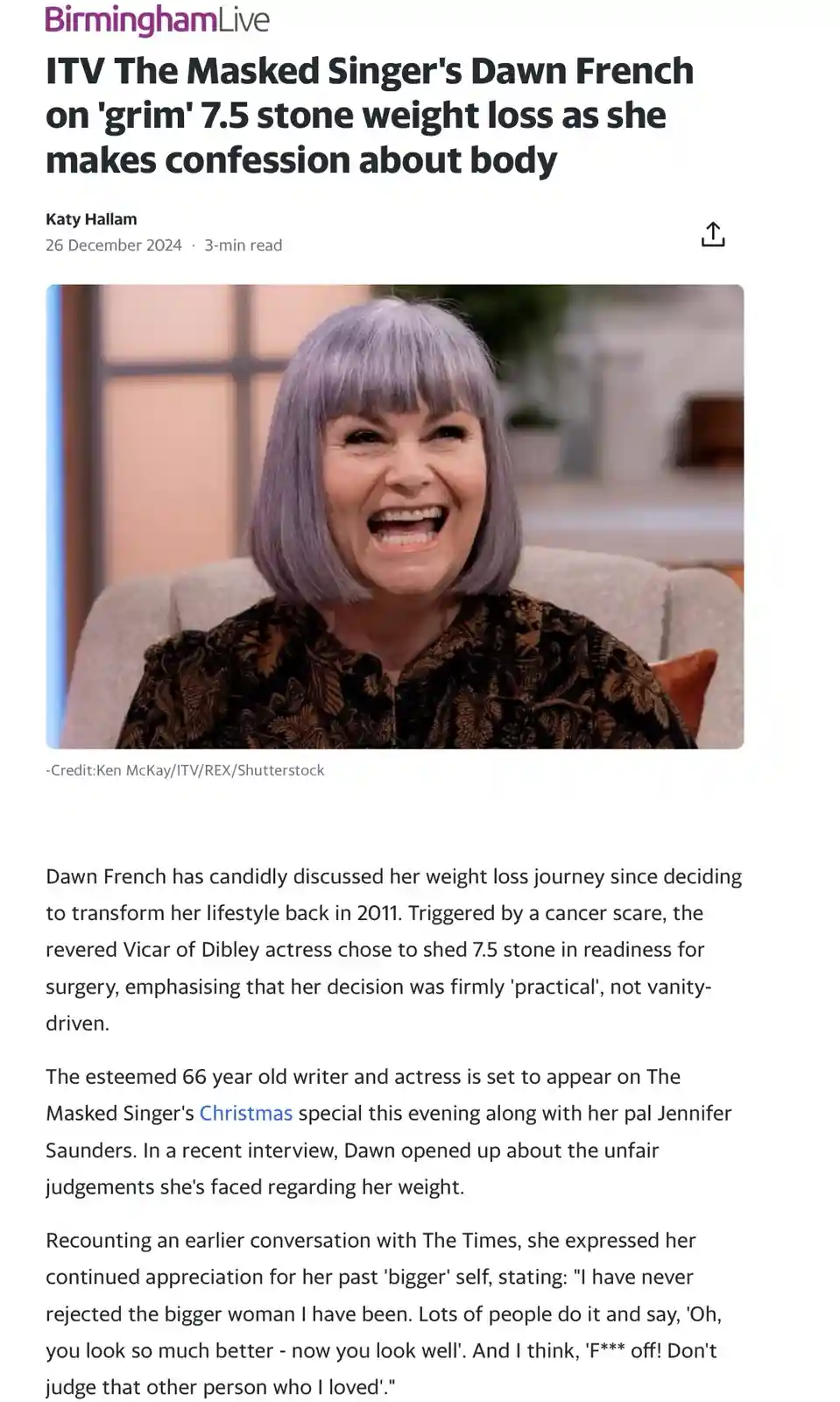 A woman with short, light purple hair and a wide, joyful smile sits in a chair wearing a dark patterned top. The overlaid…